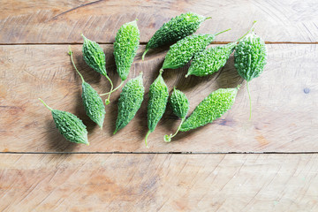 Closeup view of bitter gourd over wooden board background