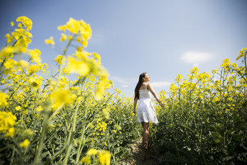 Fototapeta premium Young woman in the spring field