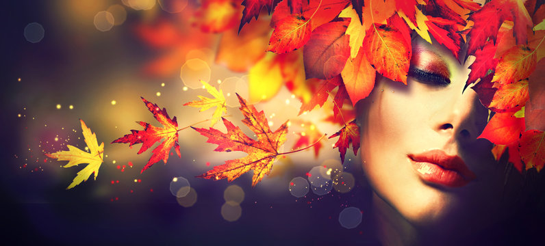 Fall. Beauty model girl with colourful autumn leaves hairstyle