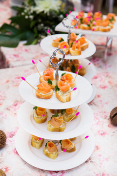 mini canapes with smoked salmon on table