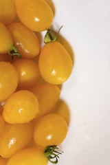 yellow cherry tomatoes on white background