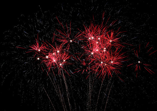 Bright red fireworks light the sky