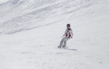 Fototapeta na wymiar Woman in suit riding snowboard
