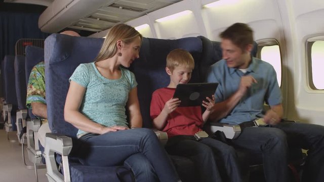 Family using tablet on plane