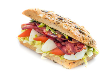 Bacon baguette with egg, tomato and lettuce. Isolated on white background.