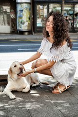 young woman on the street with a dog