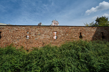 Baroque Catholic Church behind medieval defensive wall in Poznan.