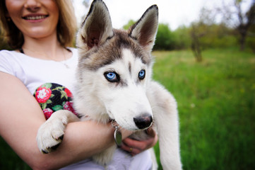 A girl and her dog husky walking in a park