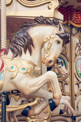 Fototapeta na wymiar White carousel horse - Old fashioned merry-go-round