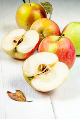 Autumn apples on a white wooden table