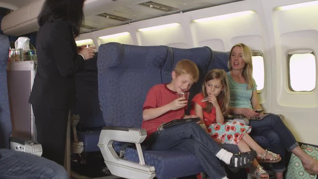 Mother with two small children on plane