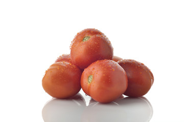 Tomatoes stacked on white background