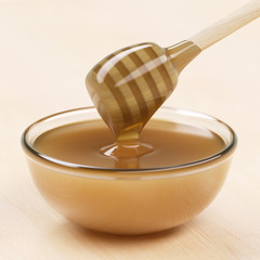 Cup of honey with dipper