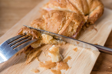 ham cheese croissant breakfast served on wooden table