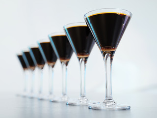 Cocktails standing in a row on white background