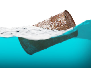 Old rusty barrel floating on the waves