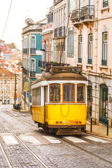 Fototapeta na wymiar Classic yellow tram on a street in Lisbon, Portugal