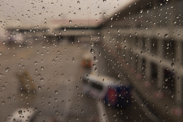 Raindrops on window glass blur background