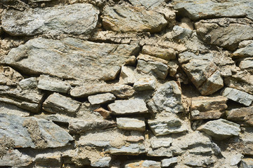 Weathered antique old cracked stone blocks wall retro background

