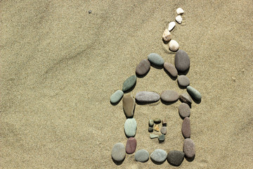 House of stones on sand background.