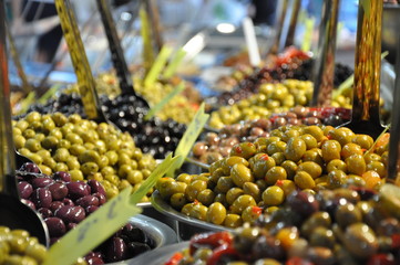 Marinated olives on street market closeup with selective focus