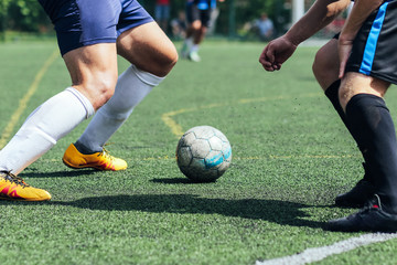 Fototapeta na wymiar Futsal / Football / Soccer. A player hits the ball on the artificial turf