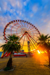 Fototapeta premium Ferris wheel on amazing sunset sky background