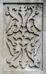 Ancient gray stone plate with vintage ornament