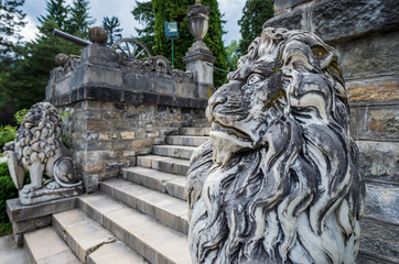 Lion statues in gardens of Peles Castle near Sinaia city in Romania