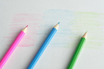 Three coloring pencils displayed on a white background