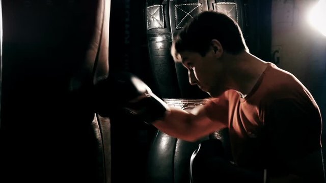 boxer hits a punching bag, slow motion