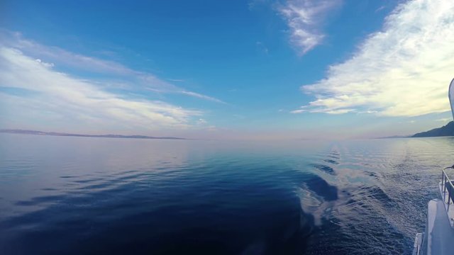 Water surface wake. Calm water and landscape view from boat. Background with copyspace. 4K video