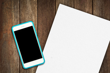 Top view on a table with a paper and phone