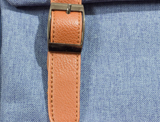 Fabrics, denim blue with a brown strap .