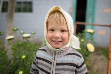 boy in scarf emotional portrait outdoors in summer
