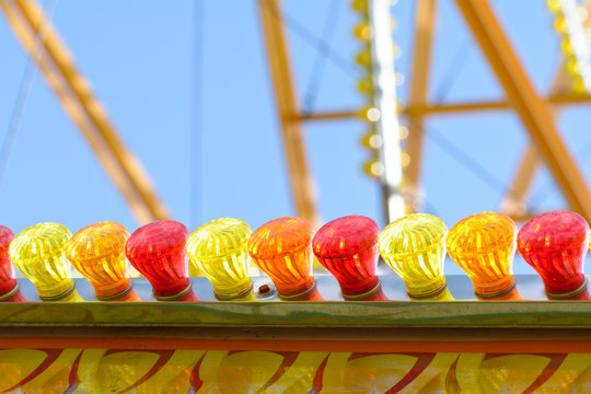 Bright colourful glass light bulbs on Big Wheel fun fair ride