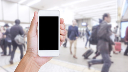 Hand holding mobile phone with blurred image of people use for b