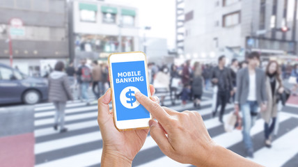 Hands holding smartphone with Mobile Banking application on scre