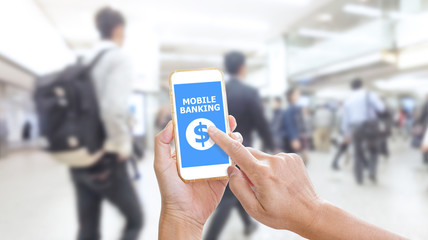 Hands holding smartphone with Mobile Banking application on scre
