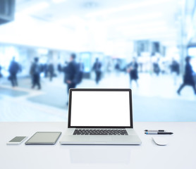 Laptop computer with blurred image of business people background