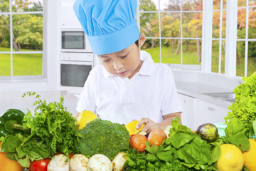 Male child preparing healthy vegetables