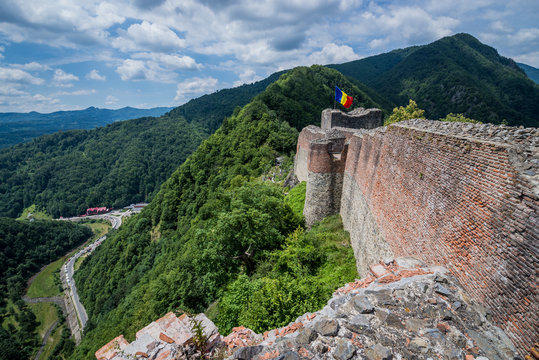 Flag on ruined Poenari Castle on Mount Cetatea in Romania