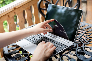 Woman Working Outdoors On Terrace, Touching Screen Of Business Tablet