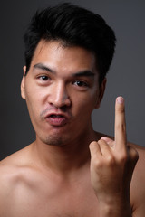 Asian man shirtless with middle finger