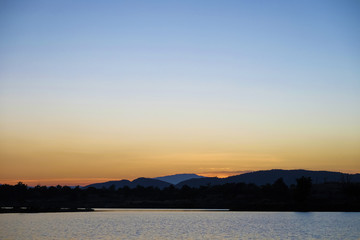 Fototapeta na wymiar Beautiful sky, lake and hill at sunset