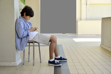 Boy playing with cell phones