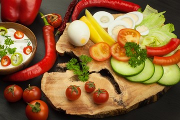 Fresh vegetables for snacks with dressing. Dip for vegetables. Healthy diet meal for dinner. Preparing vegetables in a home kitchen.
