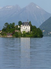 Fototapeta premium View across Brienzersee Lake, Switzerland towards Iseltwald castle and Niesen mountain beyond 