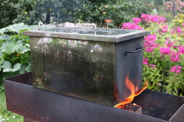 Smokehouse - a metal box with the meat on the fire
