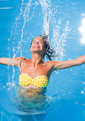 young woman doing a spin with her hair © Netfalls